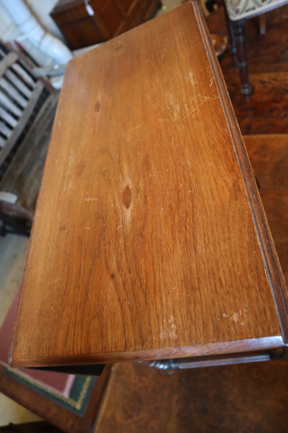 A Victorian Aesthetic period mahogany occasional table, with canted flaps and galleried understage, width 61cm